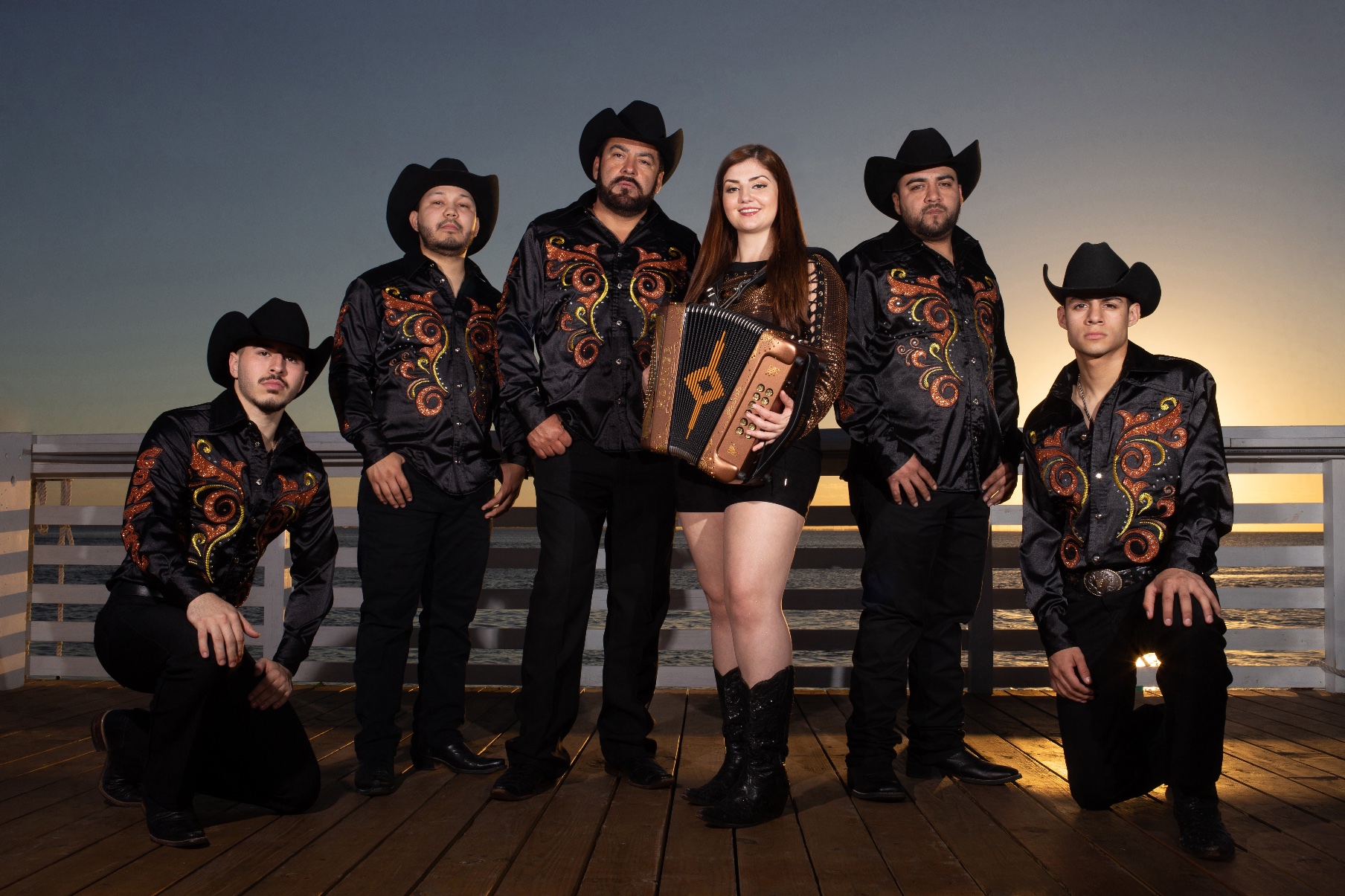 Norteño band portrait at sunset.